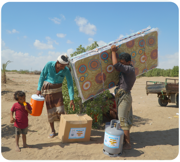Families carrying aid supplies